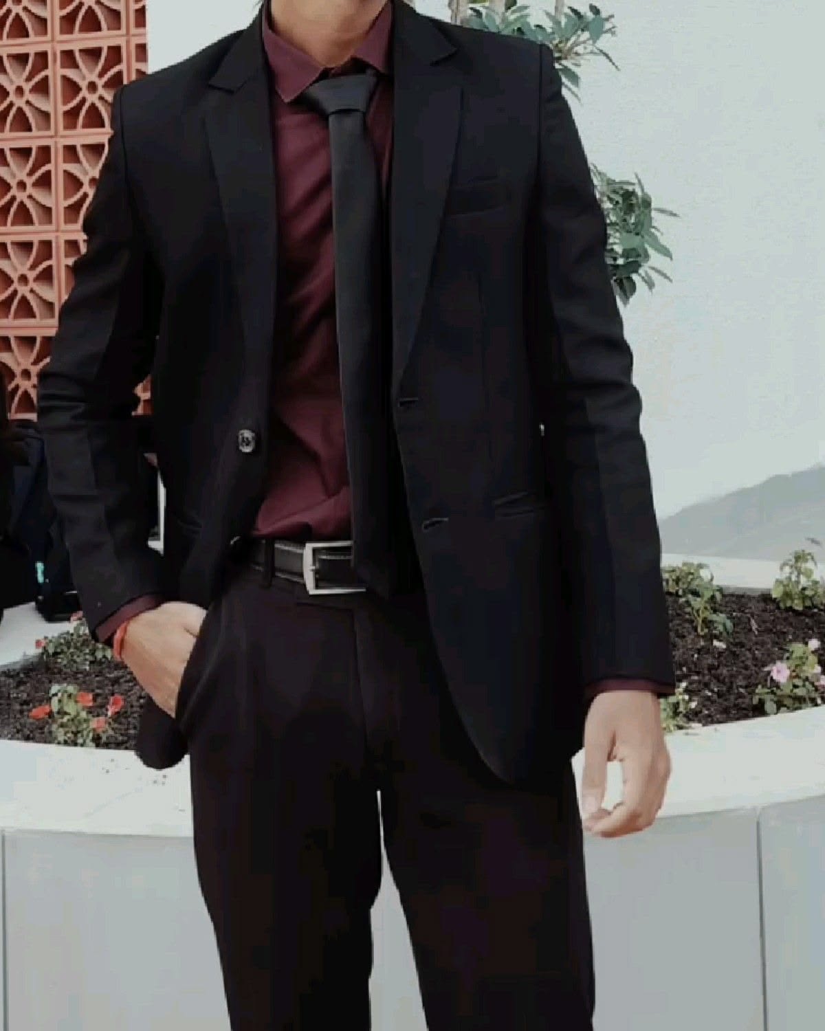 Black suit with burgundy shirt and black tie